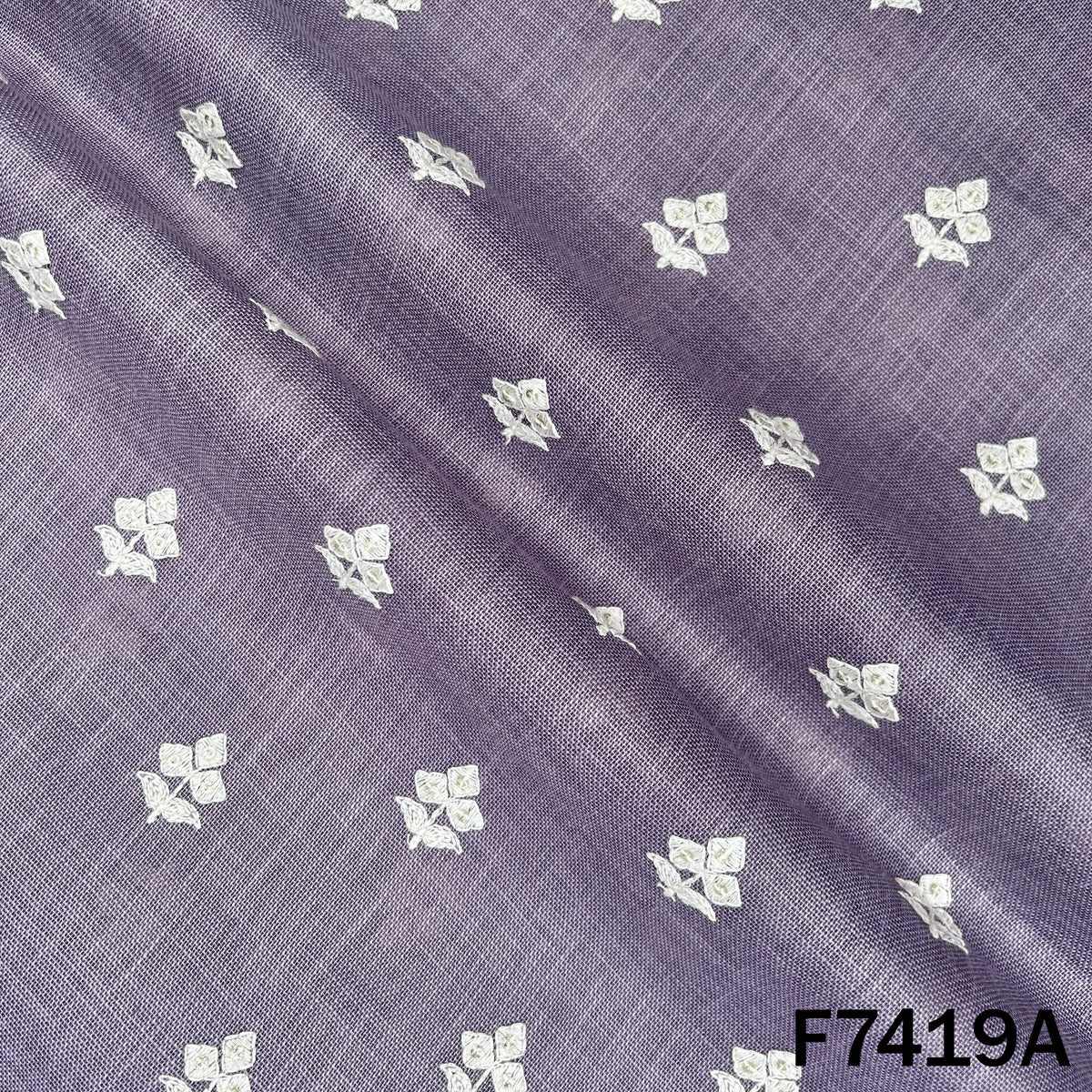 Lavender designer linen fabric with scattered thread motifs