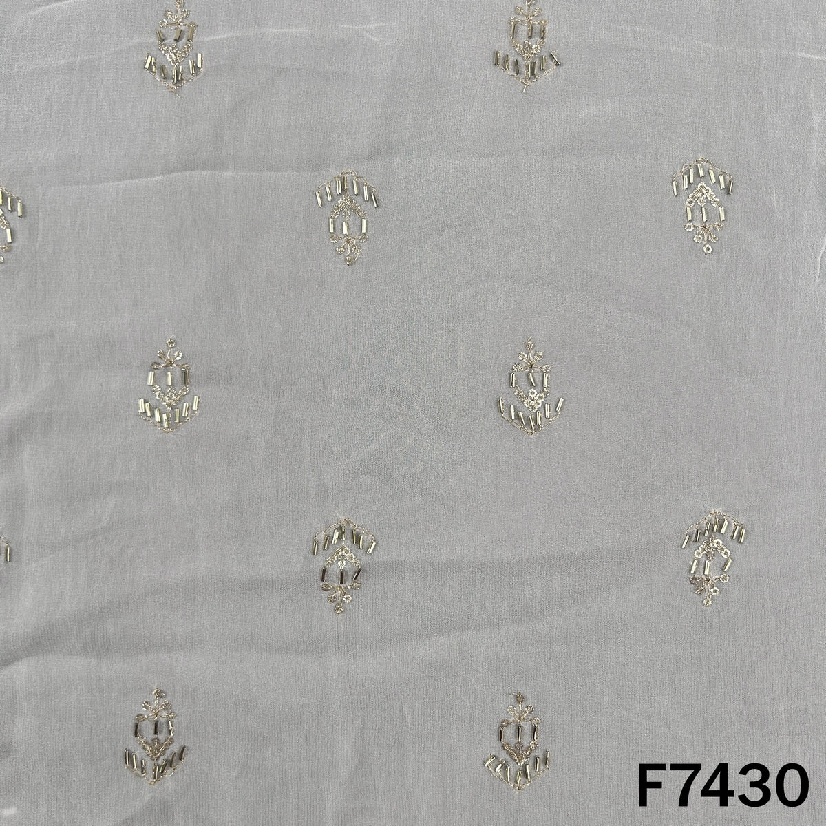 White georgette fabric with spaced metallic embroidered motifs