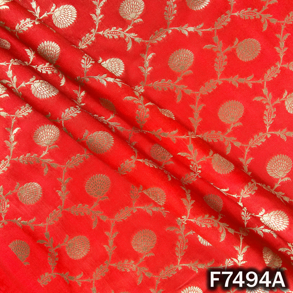 Red designer brocade fabric with golden vine motifs