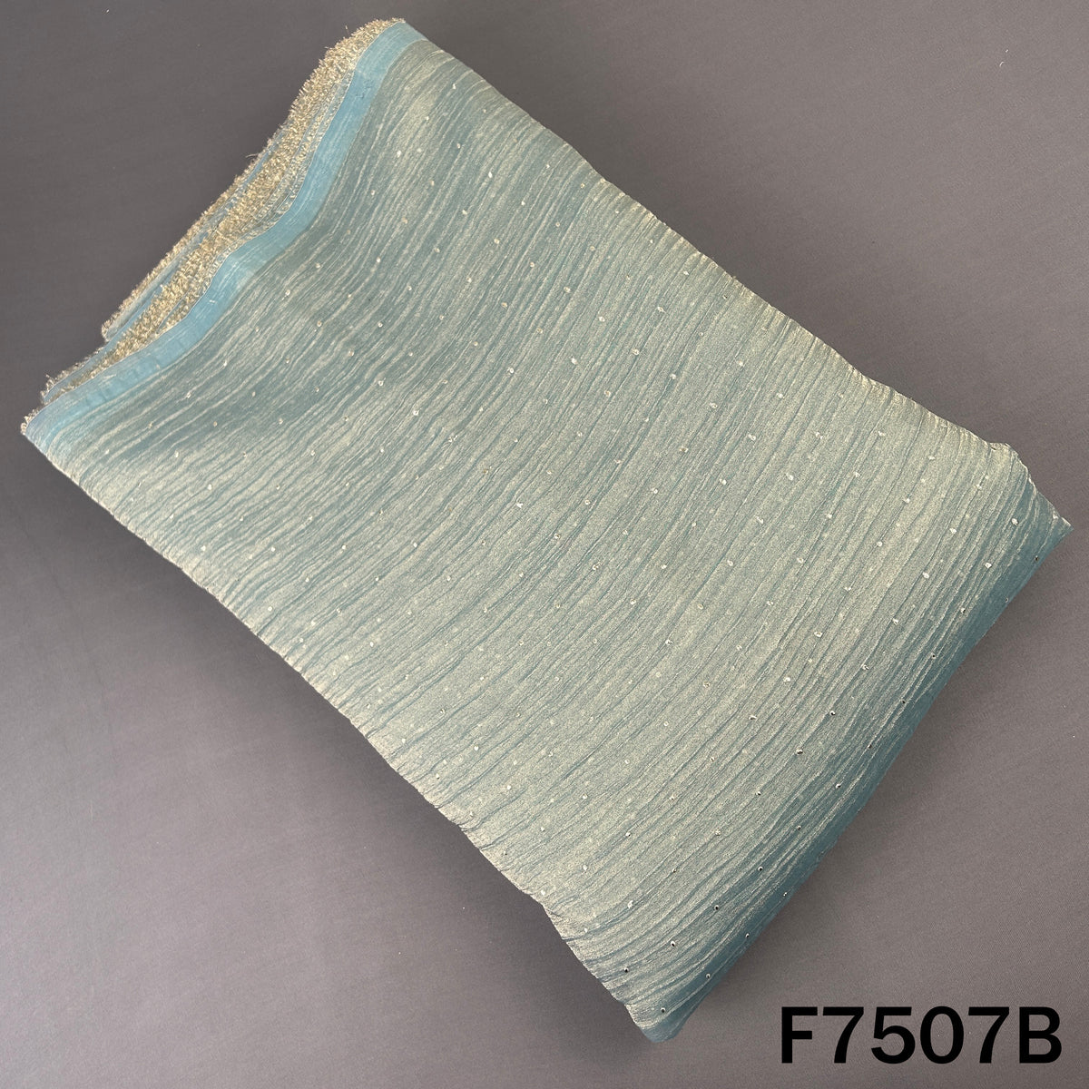 Blue crush tissue fabric with subtle dew drop work