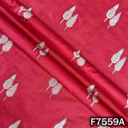 Draped crimson brocade fabric showing metallic leaf weaving