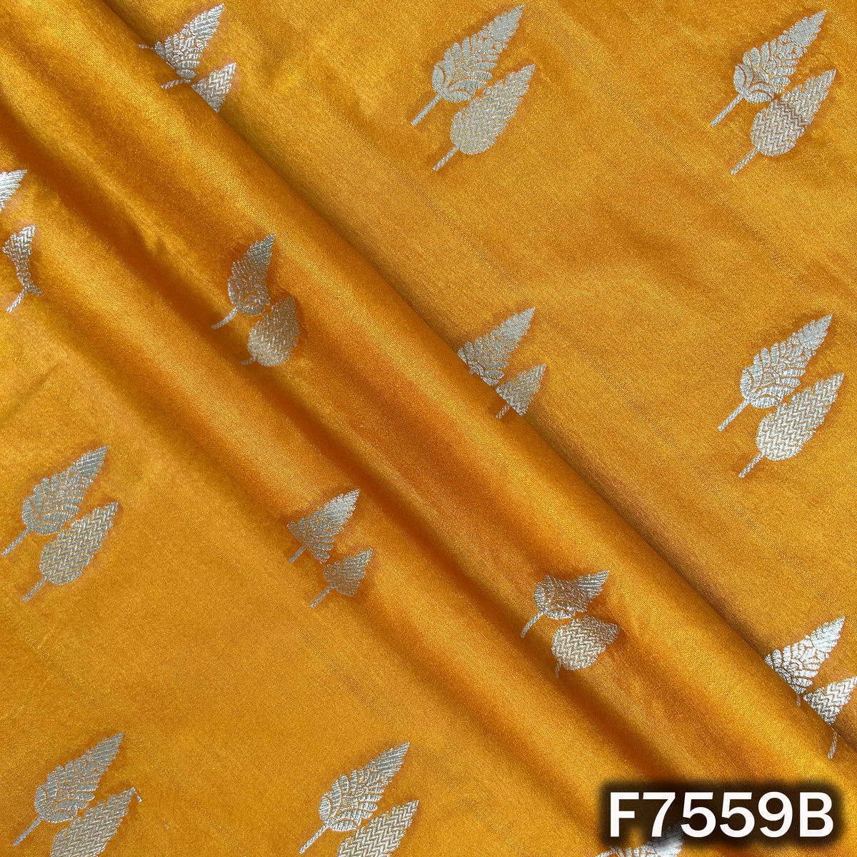 Mustard silk brocade draped with shimmering zari work