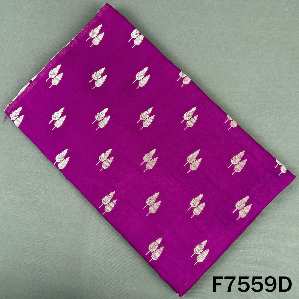 Magenta brocade silk fabric adorned with silver butis