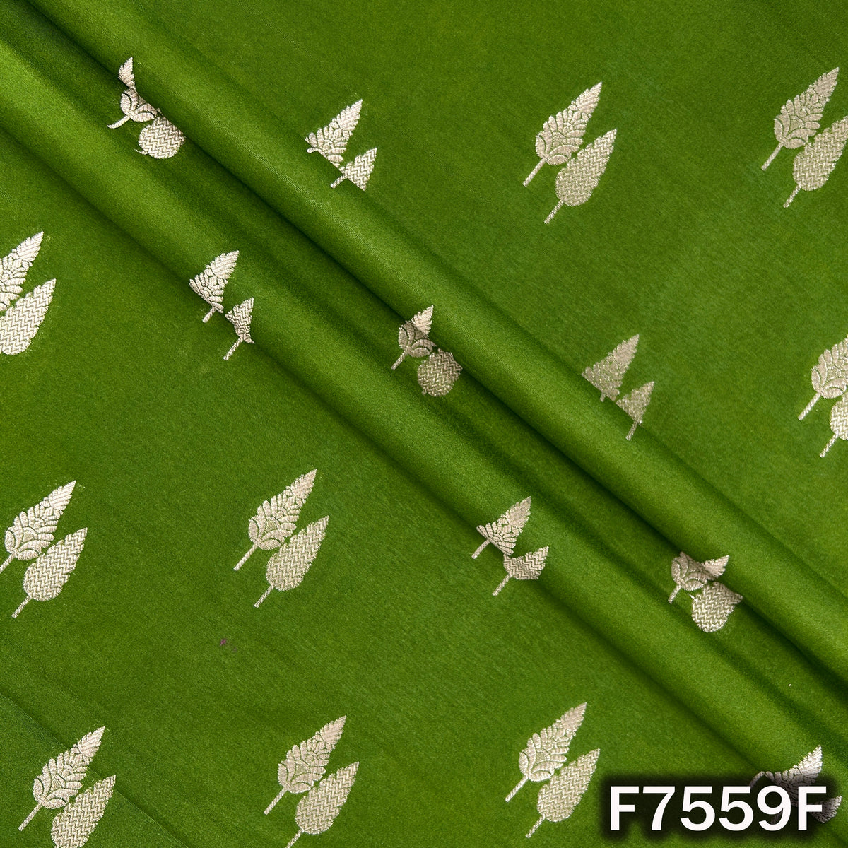 Draped green silk brocade revealing scattered zari foliage