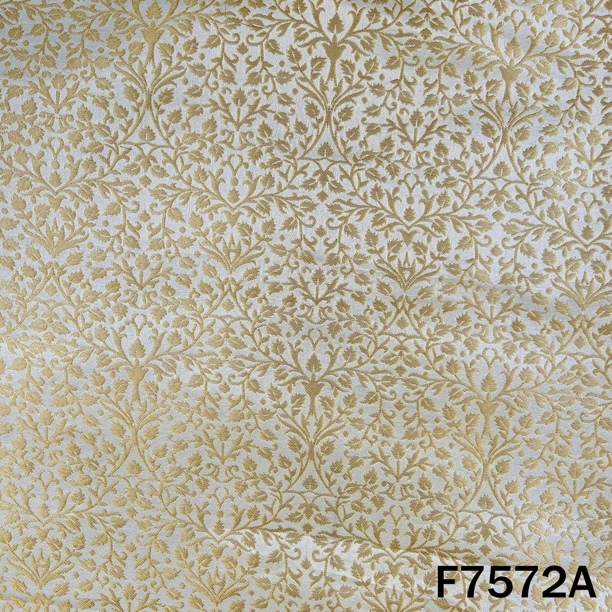 Dyeable gold brocade silk with dense leafy motifs