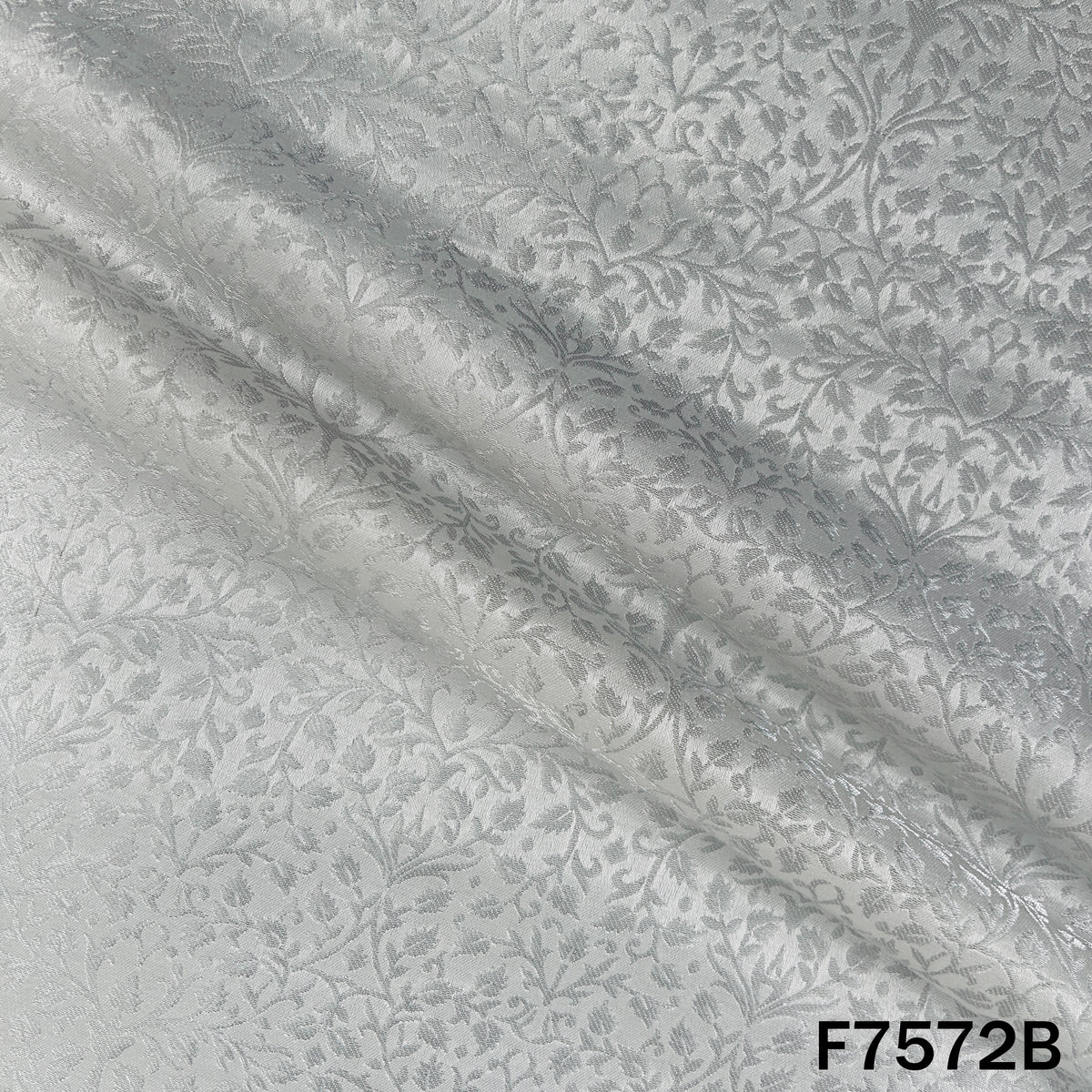 Dyeable silver brocade fabric featuring shimmering leafy weave