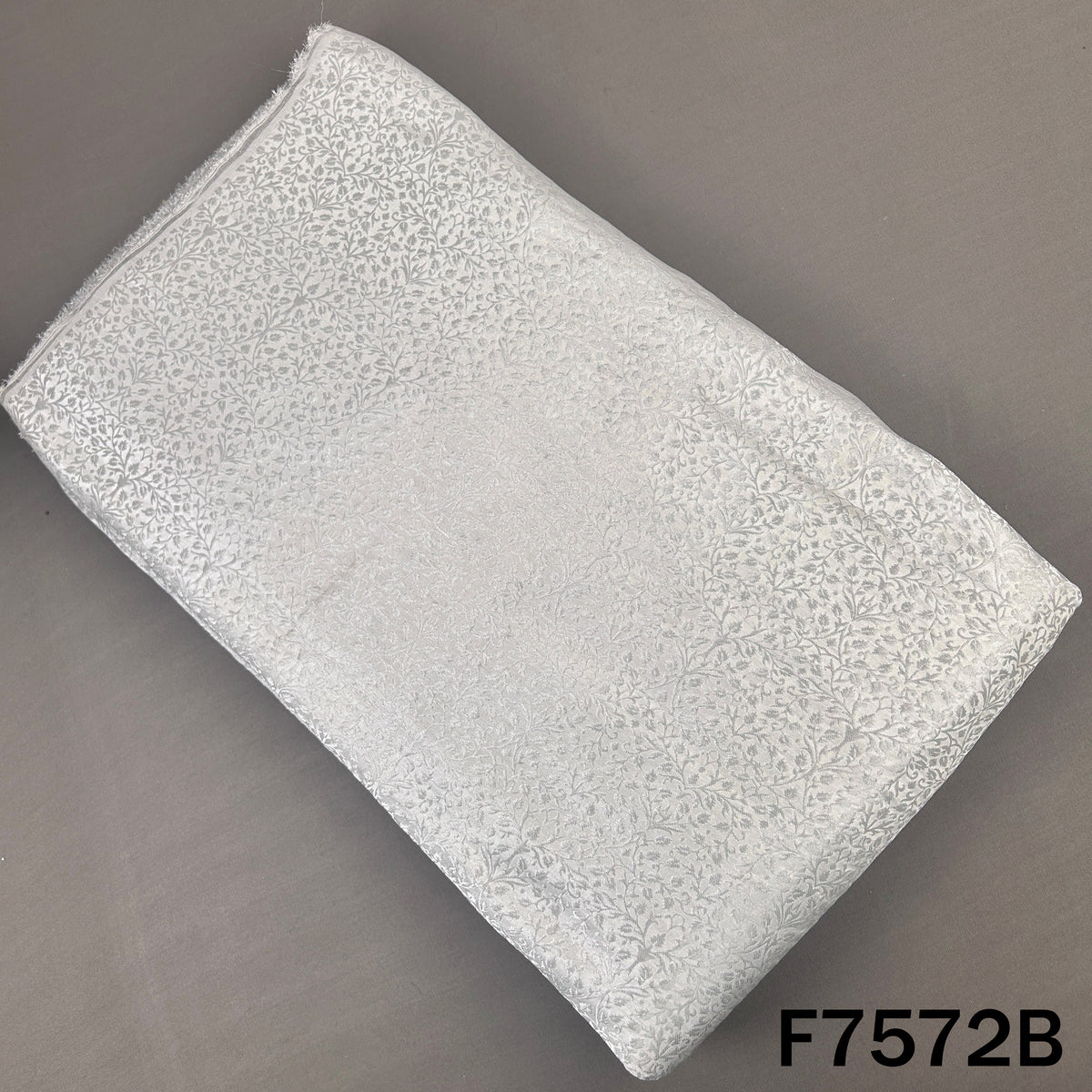 Silver brocade silk fabric with delicate floral pattern