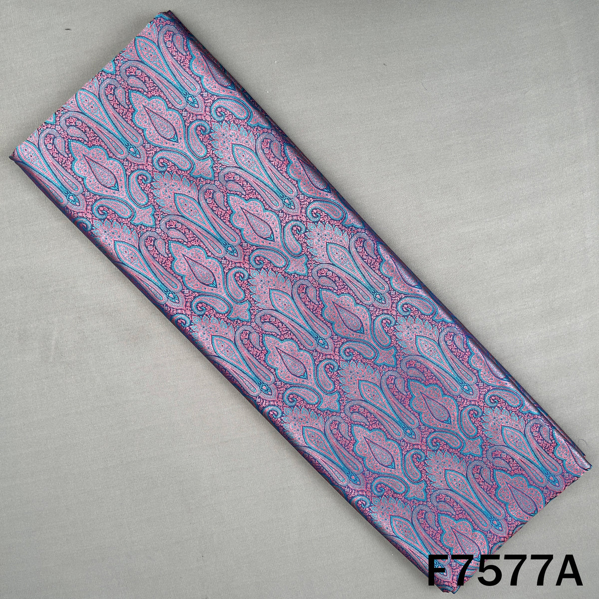 Purple brocade fabric with intricate paisley weaving