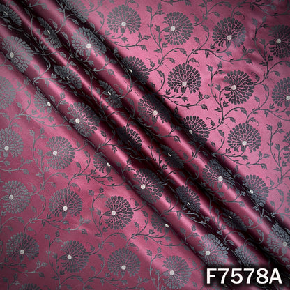 Draped wine brocade fabric with subtle zari motifs