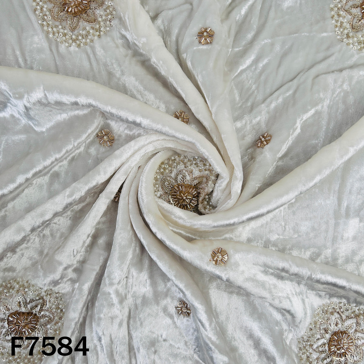 Draped ivory crushed velvet with scattered golden embroidery
