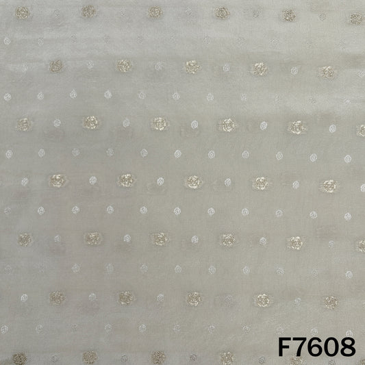 Dyeable shimmer tissue fabric with evenly spaced golden zari butti work