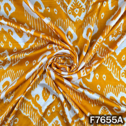 Draped yellow modal satin fabric with white traditional motifs