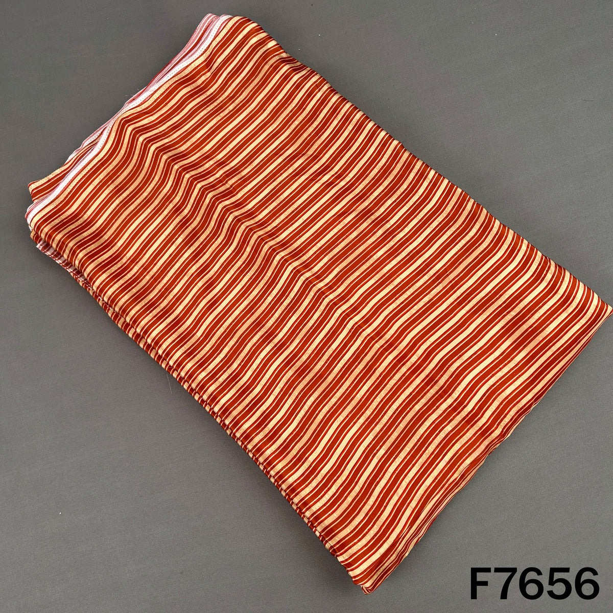 Rust orange crepe fabric with fine cream vertical stripes