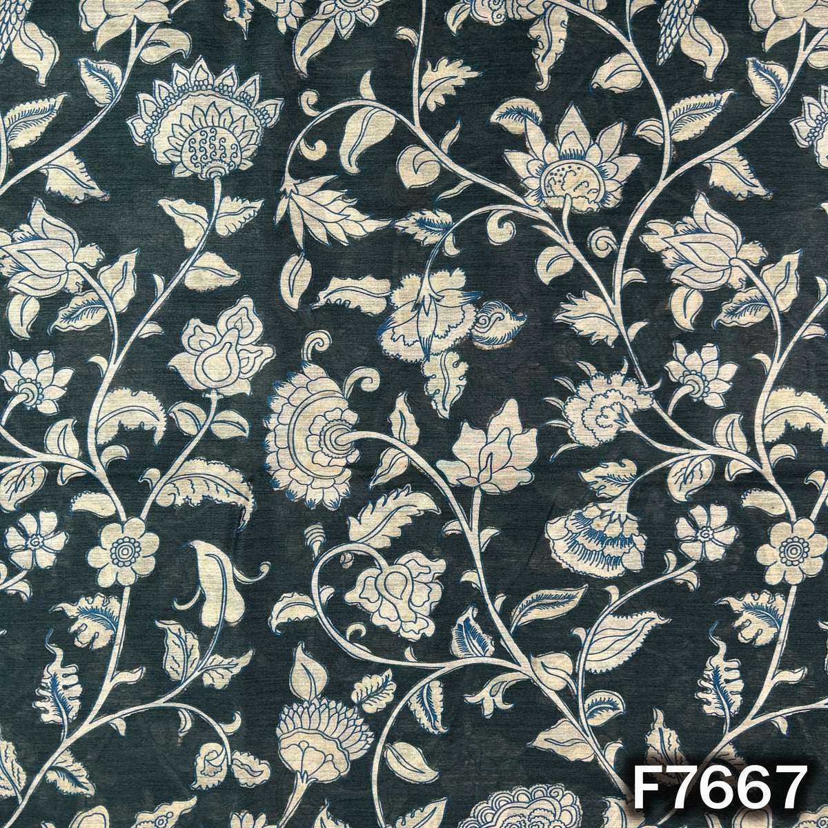 Dark green Monga silk fabric with intricate ivory floral and leafy motifs