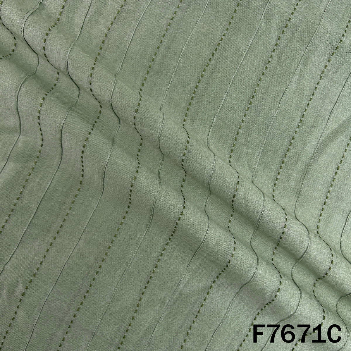 Draped mint green Monga silk with linear threadwork