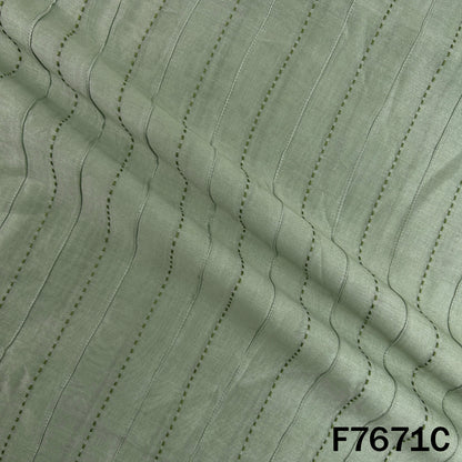 Draped mint green Monga silk with linear threadwork
