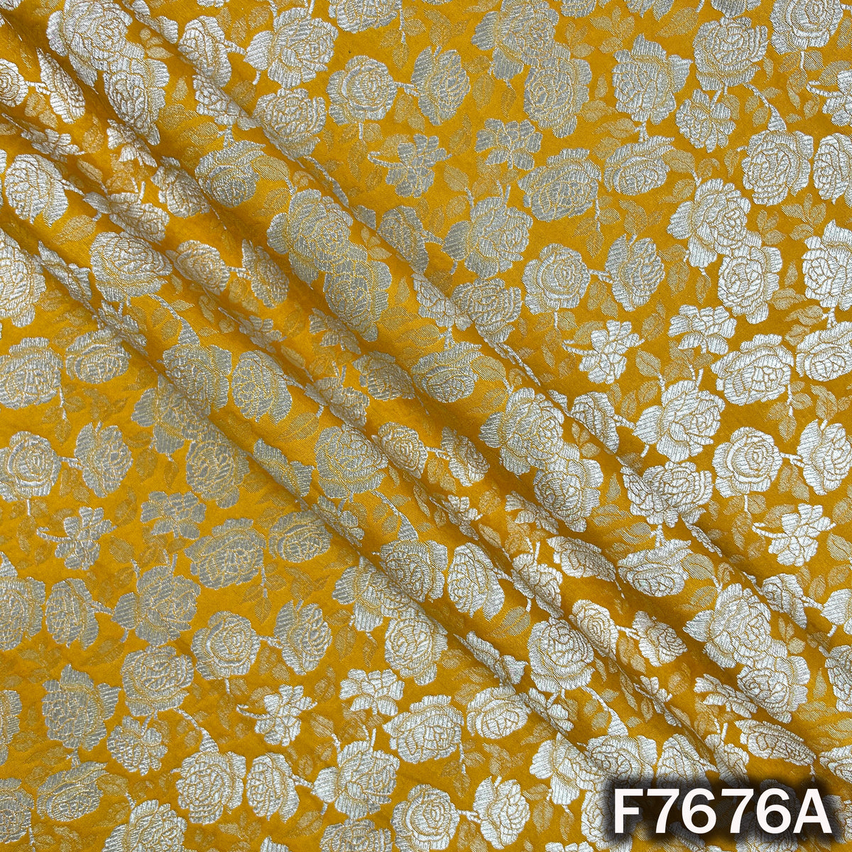Draped yellow brocade fabric with floral zari weaving