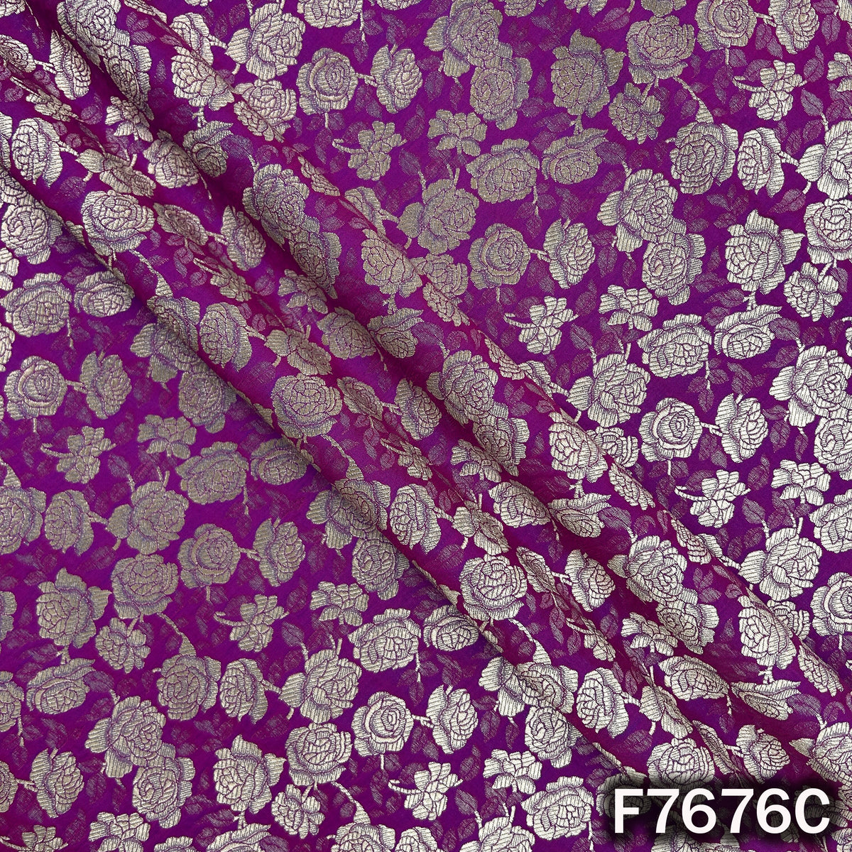 Draped purple brocade fabric with floral zari weaving