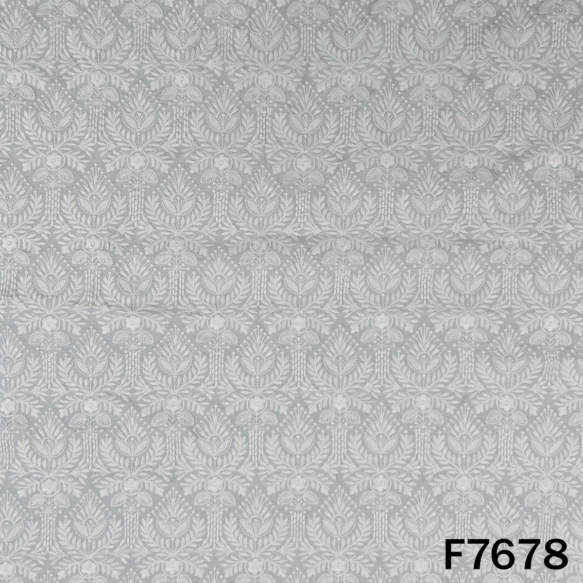 Ivory raw silk fabric with intricate tone-on-tone floral motifs