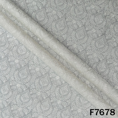 Draped ivory raw silk fabric with delicate floral embroidery