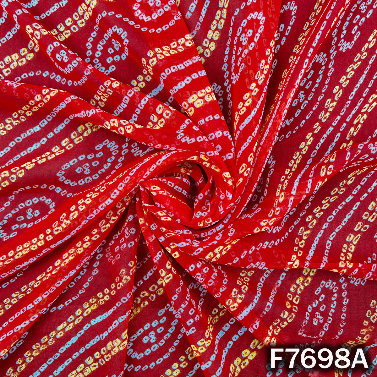 Draped red georgette with white Bandhani paisley motifs