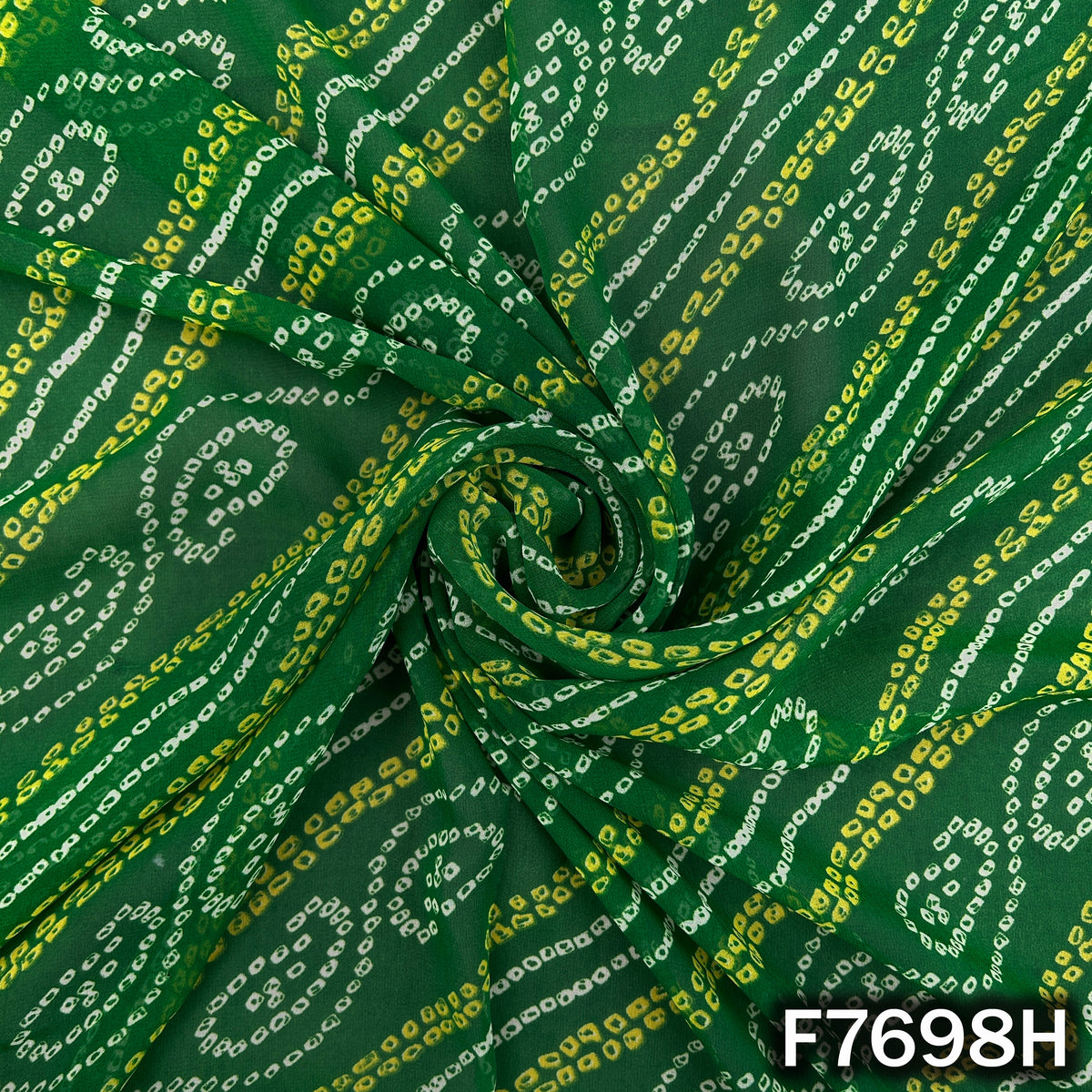 Draped dark green georgette with colorful Bandhani patterns