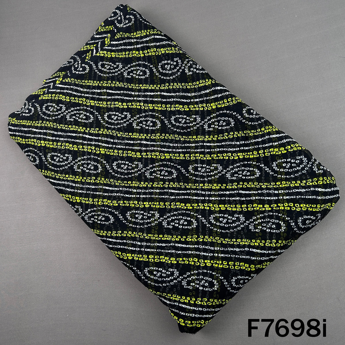 Black georgette fabric with yellow Bandhani paisley stripes