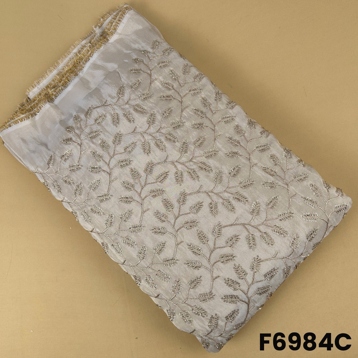 Ivory shimmer tissue fabric F6984C designed with delicate zari sequins embroidery on a soft luxury base