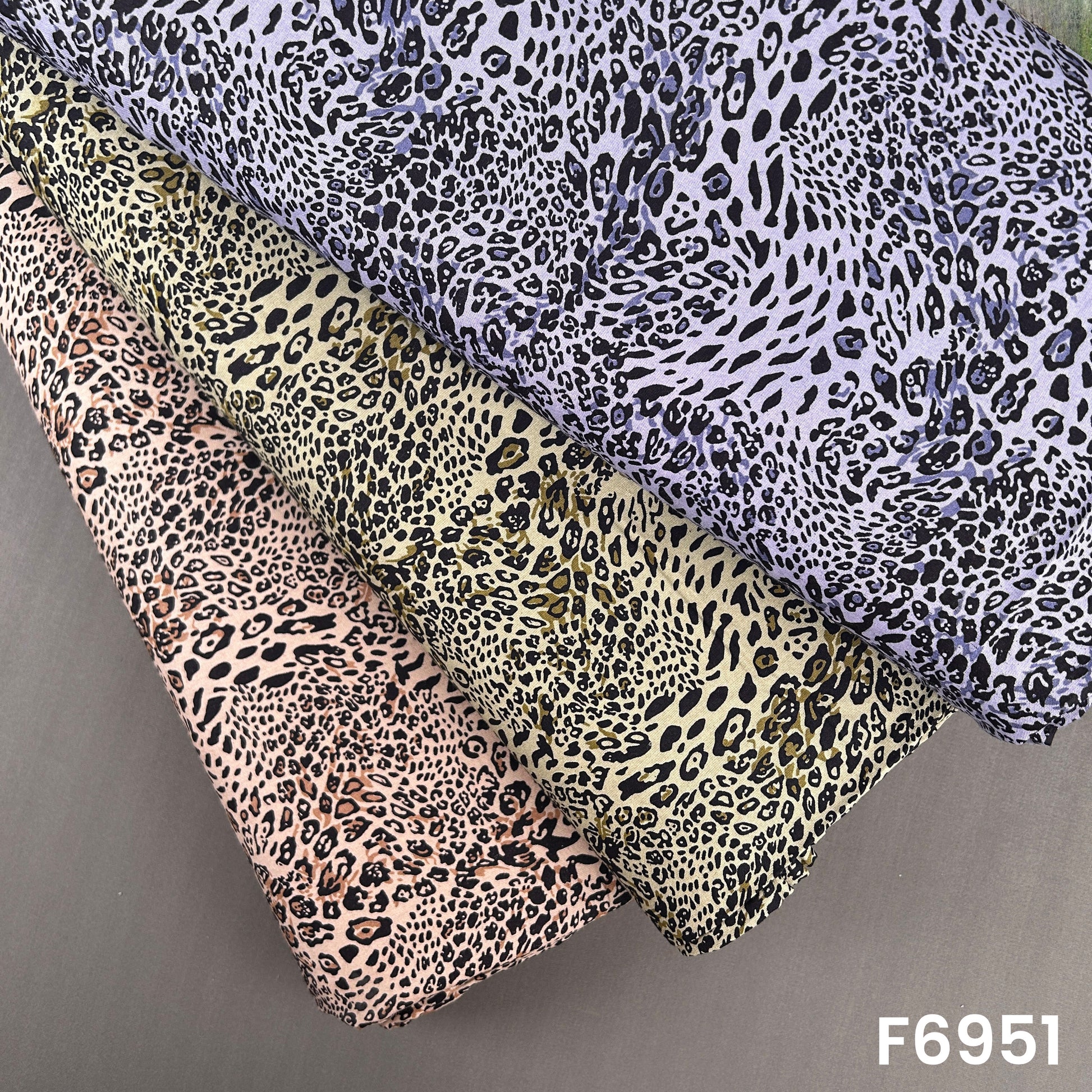 Animal print rayon fabric F6951 displayed in beige, olive, lavender and brown leopard-inspired colorways
