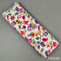 White rayon fabric F6948 covered with lively paisley vines in pink, green, blue, mustard and coral shades