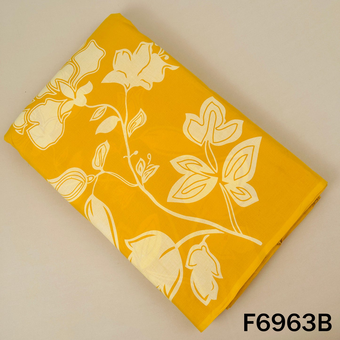 Mustard yellow Printed Cotton fabric F6963B designed with bold white floral artwork for standout outfits
