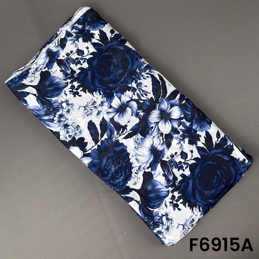F6915A Crepe Satin fabric featuring large blue flowers, dark leafy patterns and a polished satin finish
