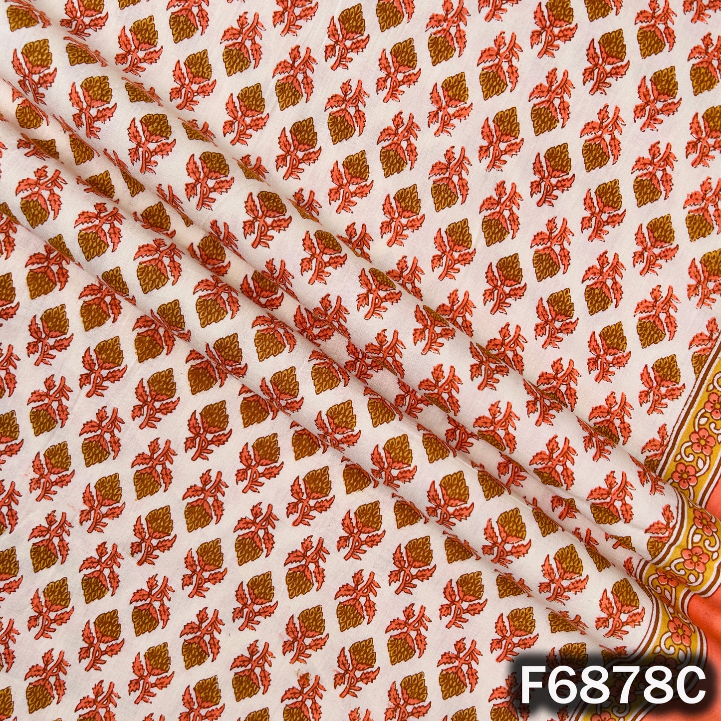 Close-up of orange block print cotton fabric F6878C with vibrant floral pattern