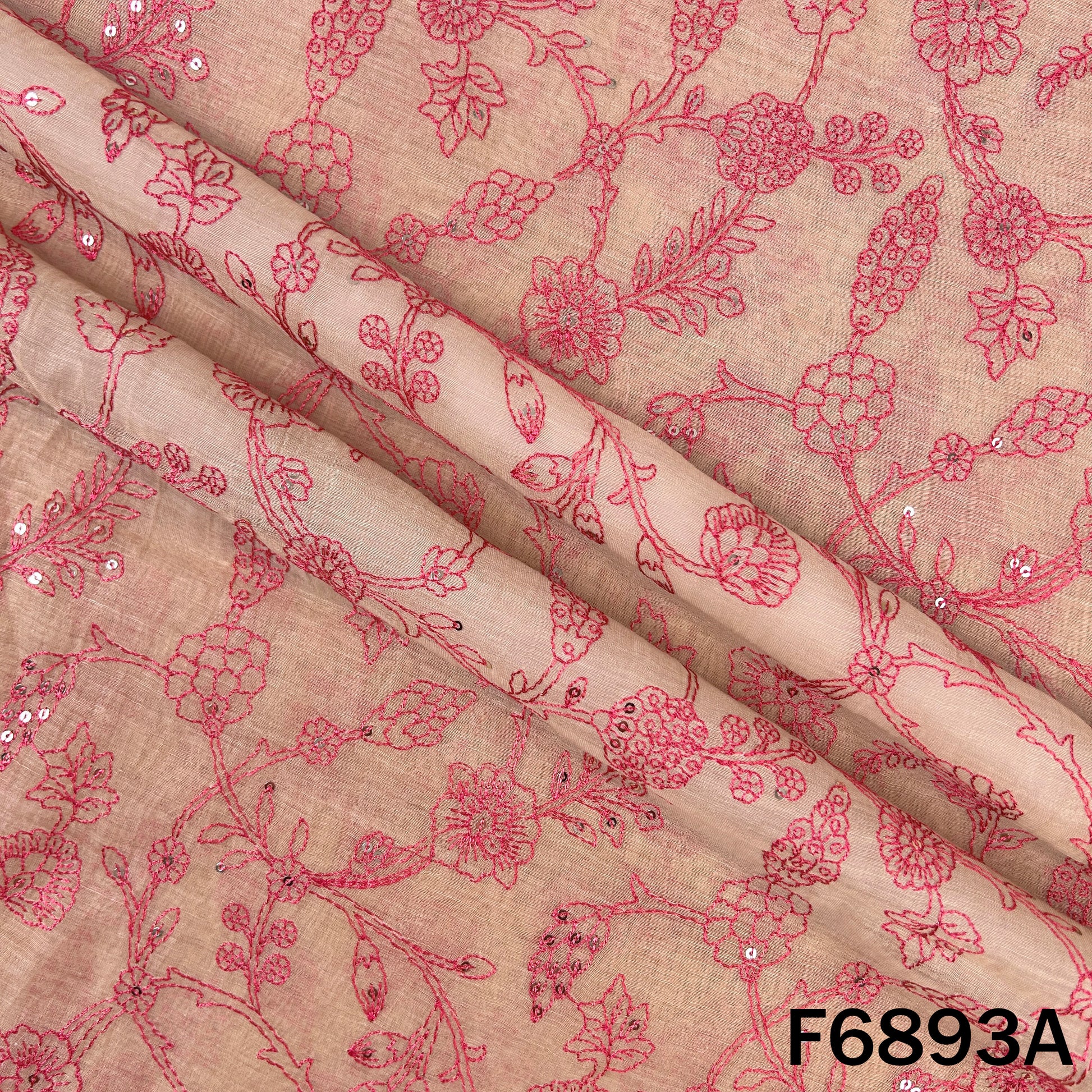 Close view of pink F6893A Chanderi fabric showing elegant floral embroidery on a soft base