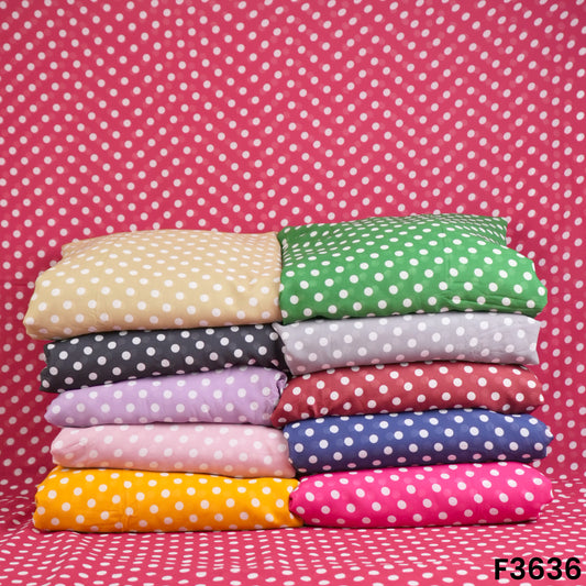 A stack of folded fabrics featuring a polka dot pattern in various colors including yellow, green, gray, pink, blue, red, and purple, displayed on a matching polka dot background.