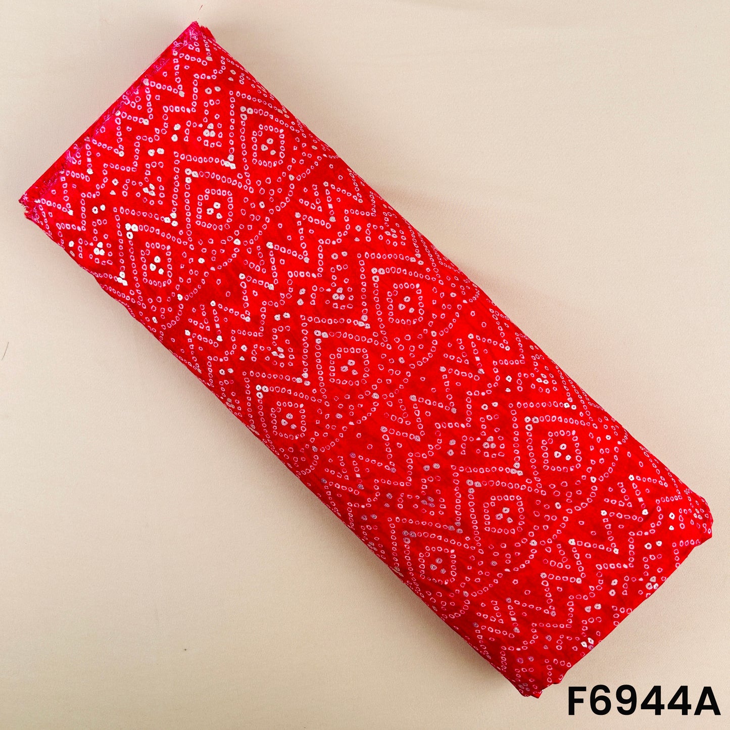 Bright red rayon fabric F6944A decorated with silver foil accents and traditional geometric Bandhani motifs