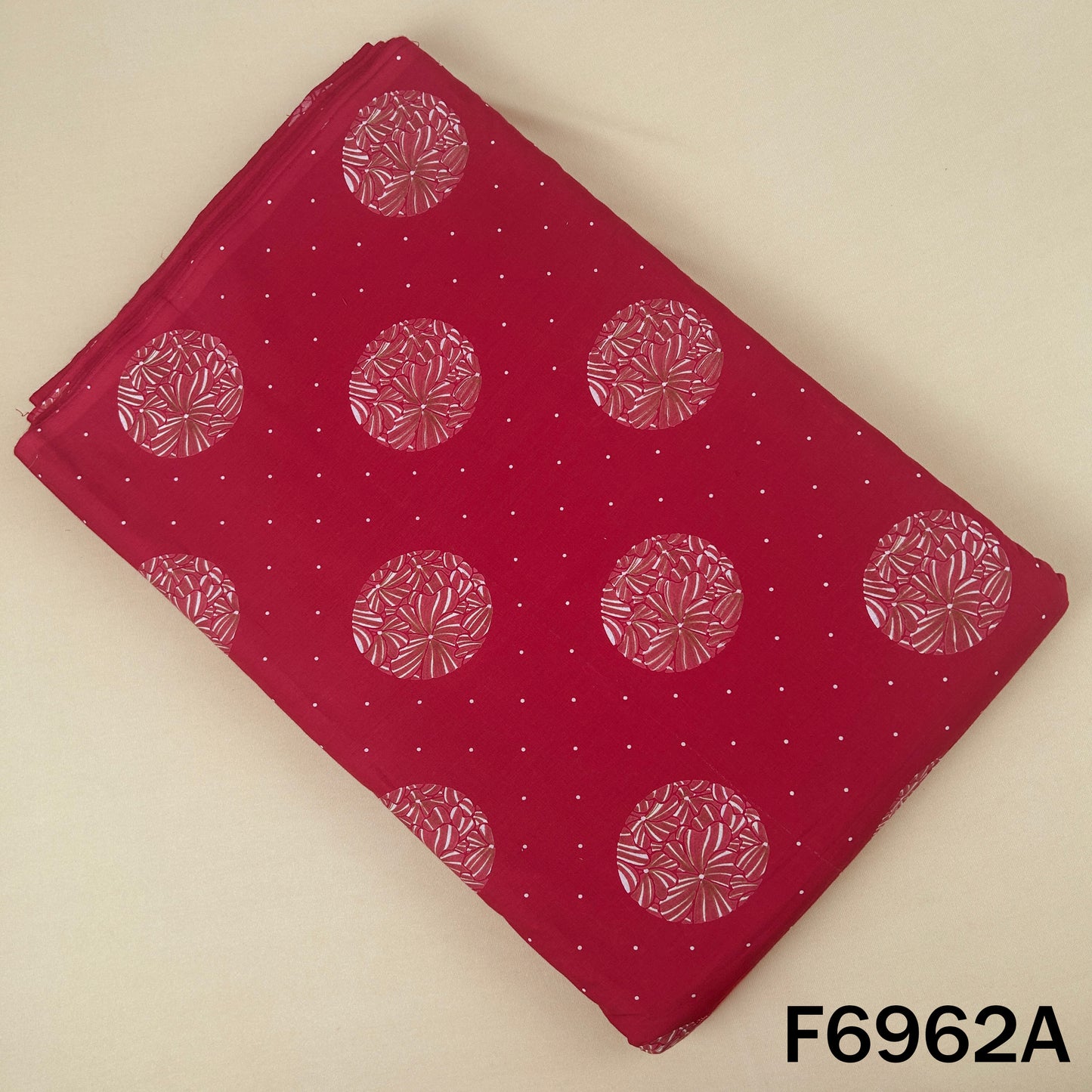 Red cotton fabric F6962A featuring pink circular floral motifs with tiny dotted accents on a rich base