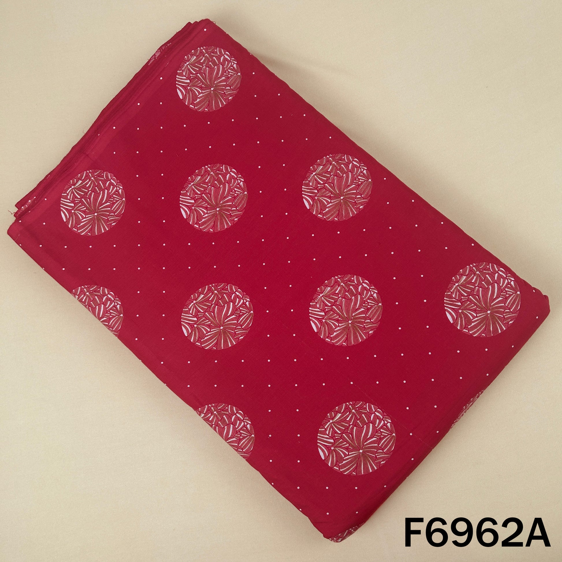 Red cotton fabric F6962A featuring pink circular floral motifs with tiny dotted accents on a rich base