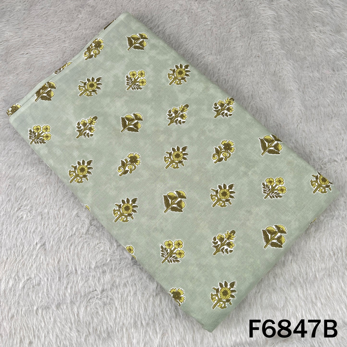 Sage green cotton fabric featuring traditional golden-yellow floral block prints - F6847B