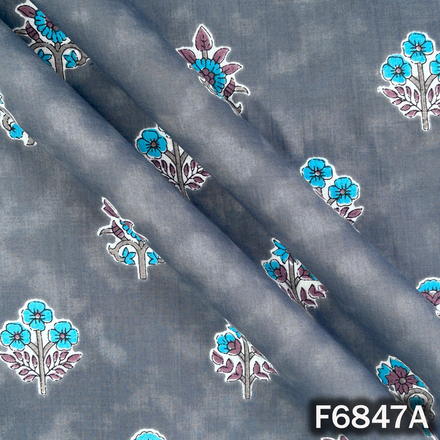 Close-up texture of slate blue premium cotton fabric with floral design F6847A