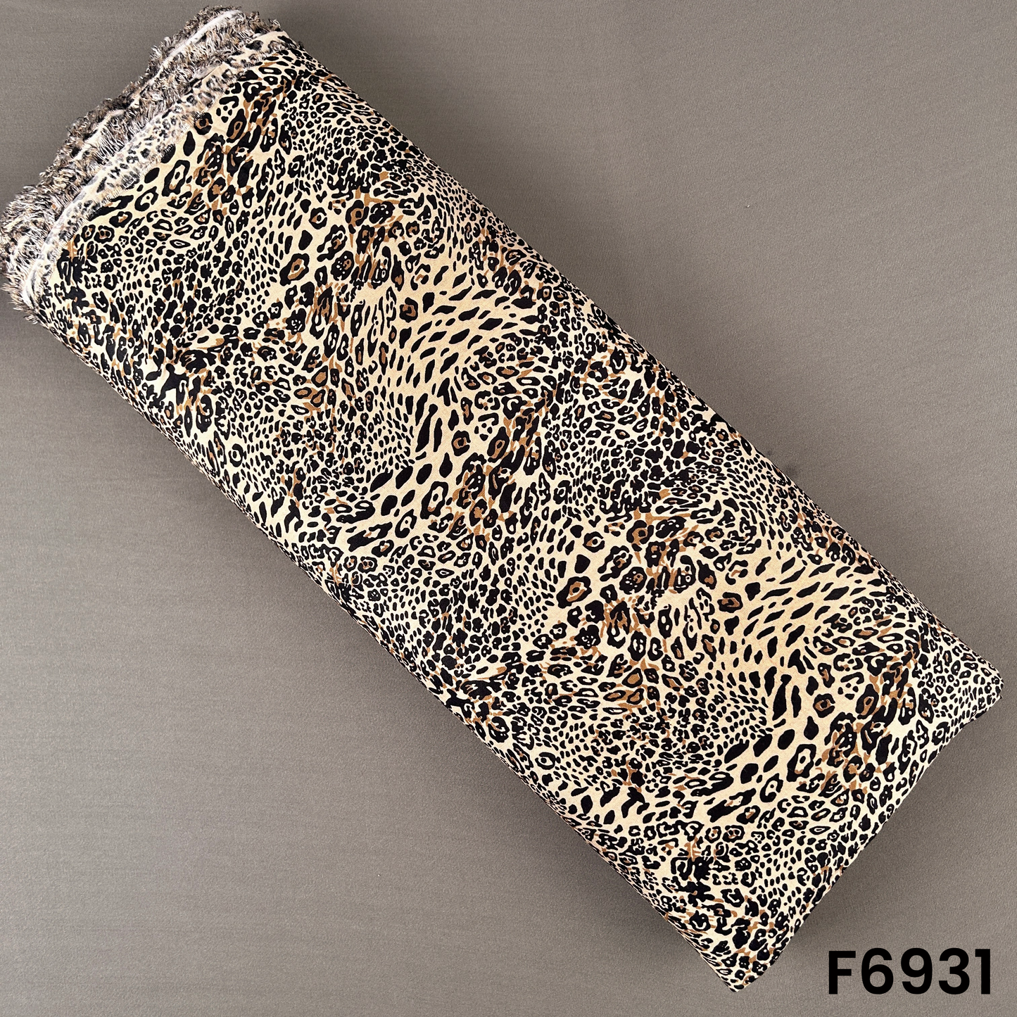 Tiger print rayon fabric F6931 with beige, brown and black animal-inspired pattern on a soft flowing base